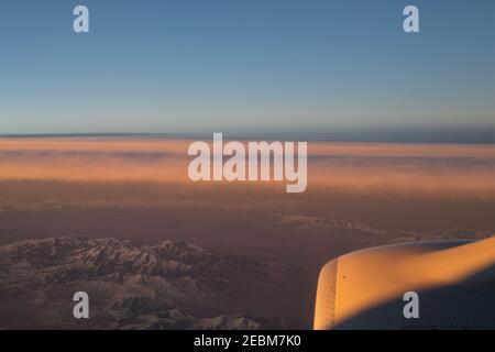 A section of the Rocky Mountains in the western part of the United States, as seen at sunrise from an airplane. Stock Photo