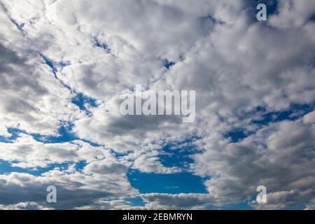 Scenic white clouds float across the blue sky Stock Photo