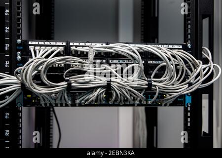 A lot of network cables connected in a big network switch Stock Photo