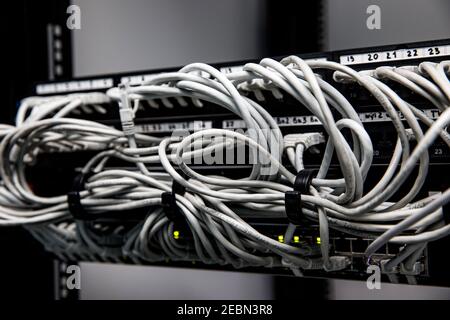 Network panel, switch and cables in data center Stock Photo