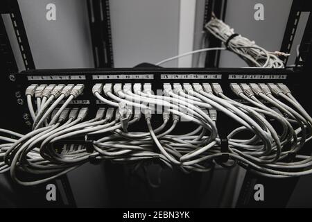 A lot of network cables connected in a big network switch Stock Photo