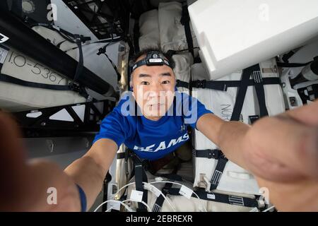 JAXA astronaut and Expedition 64 Flight Engineer Soichi Noguchi takes a selfie as he loads cargo inside the SpaceX Cargo Dragon resupply ship ahead of its undocking and departure aboard the International Space Station January 10, 2021 in Earth Orbit. Stock Photo