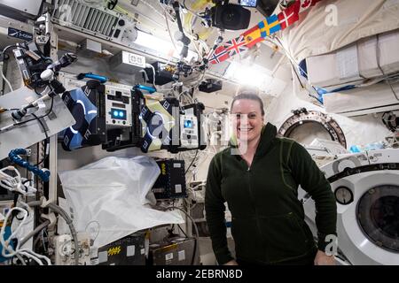 NASA astronaut and Expedition 64 Flight Engineer Kate Rubins poses with a pair of AstroBee robotic assistants inside the Japanese Kibo laboratory module aboard the International Space Station February 4, 2021 in Earth Orbit. The cube-shaped, toaster-sized robots are being tested for their ability to autonomously navigate and maneuver inside the orbiting lab. Stock Photo