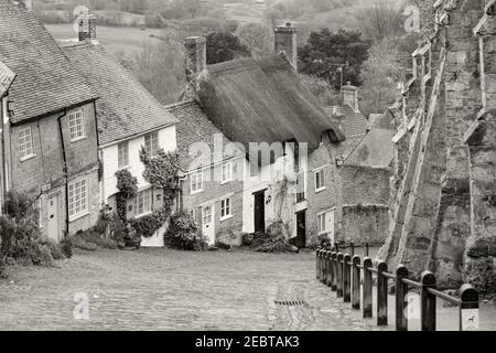 Gold Hill is a steep cobbled street in the town of Shaftesbury in the English county of Dorset. The view looking down from the top of the street has b Stock Photo