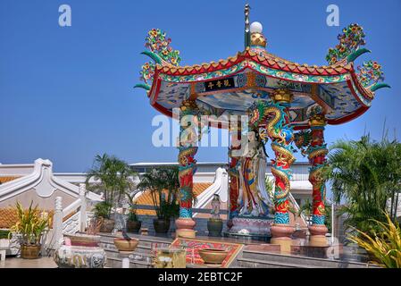 Kuan Yin (aka) Quan Yin or Kwan Yin - Chinese goddess of compassion in a Chinese pagoda shrine setting, Summer skies, Copy space, room for text Stock Photo