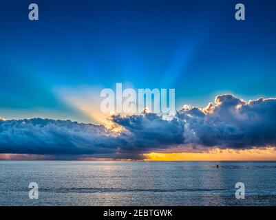 Dramatic sunset sky over sea Stock Photo