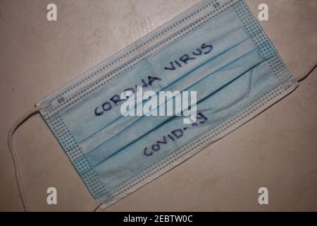 Face op mask with hand write text corona virus covid-19 macro modern background high quality print Stock Photo