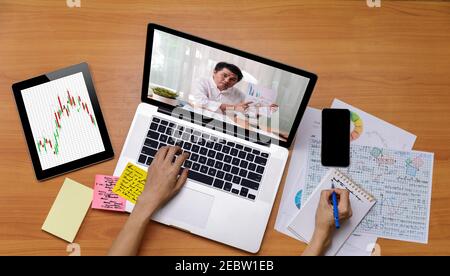 Business long distance video call, businessman and businesswoman analysis financial report using videoconference application for virtual communication Stock Photo