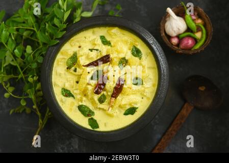 Bowl of homemade sour cream curd yogurt Dahi fresh herbs curry leaf Kerala, India. Dairy product obtained by coagulating milk a process curdling. Stock Photo