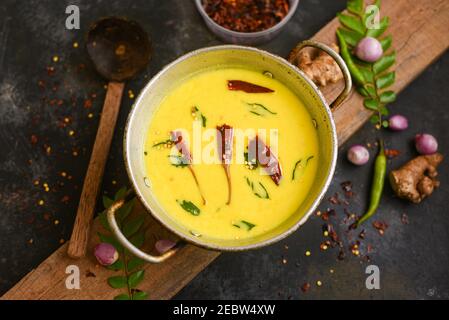 Bowl of homemade sour cream curd yogurt Dahi fresh herbs curry leaf Kerala, India. Dairy product obtained by coagulating milk a process curdling. Stock Photo