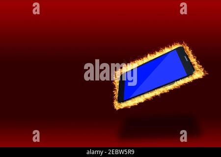 Modern black smartphone hot on fire showing blank blue screen isolated on red background with copy space. Stock Photo