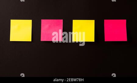 lots of colored stickers on a black background. stickers on the wall Stock Photo
