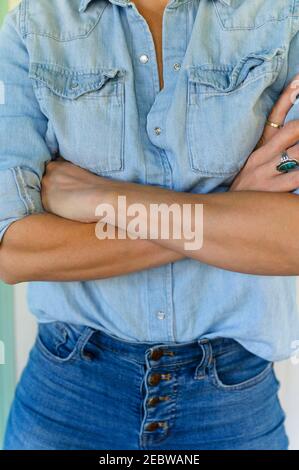 Midsection of woman with arms crossed Stock Photo
