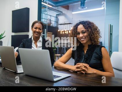 Business women using laptops in office Stock Photo