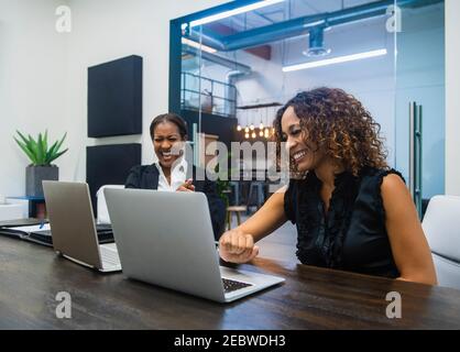 Business women using laptops in office Stock Photo