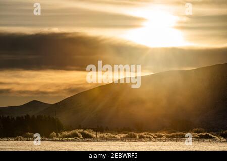 USA, Idaho, Bellevue, Sunset over snowy fields and mountains Stock Photo