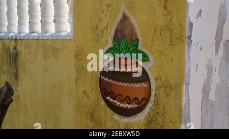 Traditional art of Kalash and coconut printed on the house wall. Auspicious sign art outside of the home wall in Hindu culture. Stock Photo