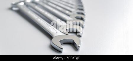 Cut-out wrenches horizontally placed from the biggest to the smallest in a row. Top view composition. Hand tool. Tools for carpentry work. Type of fas Stock Photo