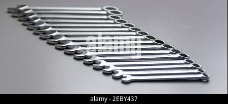 Cut-out wrenches horizontally placed from the biggest to the smallest in a row. Top view composition. Hand tool. Tools for carpentry work. Type of fas Stock Photo