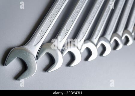 Cut-out wrenches horizontally placed from the biggest to the smallest in a row. Top view composition. Hand tool. Tools for carpentry work. Type of fas Stock Photo