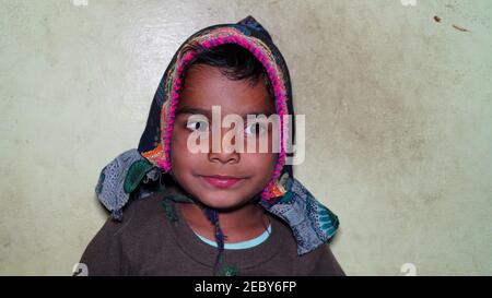 08 February 2021- Khatoo, Jaipur, India. Happy boy child is smiling enjoying adopted life. Cute blond toddler wearing a traditional hat on head. Smili Stock Photo