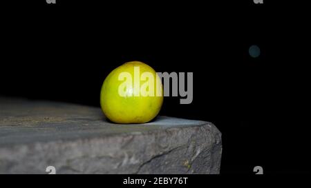 Ripe yellow lemons on the slay. Beautiful ripe Citrus fruit or Lemon holding on the slay with black background. Stock Photo