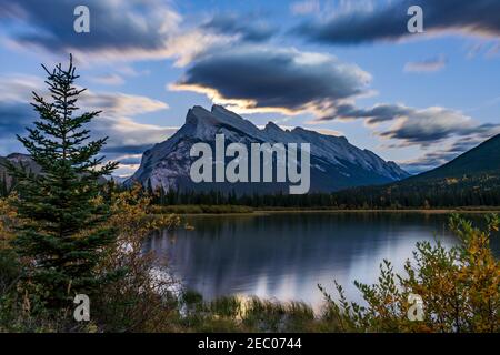 Moonrise at Vermilion Lakes in summer night. Banff National Park, Canadian Rockies, Alberta, Canada. Bright full moon over Mount Rundle Stock Photo