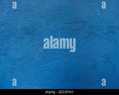 Blue painted plaster wall photo background. Old wall cracks photo texture. Blue wall with stains and grit closeup. Rustic old surface. Vintage backgro Stock Photo