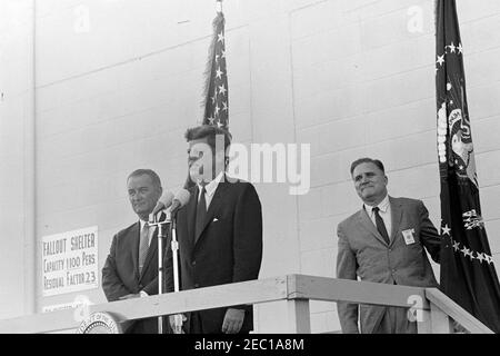 Inspection tour of NASA installations: Cape Canaveral Florida, 2:31PM. President John F. Kennedy (at microphones) delivers remarks, following a tour of Cape Canaveral Air Force Station, Cape Canaveral, Florida. Standing behind President Kennedy: Vice President Lyndon B. Johnson; Administrator of the National Aeronautics and Space Administration (NASA), Dr. James E. Webb. The President visited Cape Canaveral as part of a two-day inspection tour of NASA field installations. Stock Photo