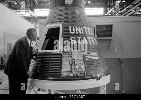 Inspection tour of NASA installations: Cape Canaveral Florida, 2:31PM. White House Secret Service agent, John J. u201cMuggsyu201d Ou2019Leary, looks inside Mercury spacecraft capsule #19 inside Hangar S, during President John F. Kennedyu0027s visit to Cape Canaveral Air Force Station, Cape Canaveral, Florida. President Kennedy visited Cape Canaveral as part of a two-day inspection tour of National Aeronautics and Space Administration (NASA) field installations. Stock Photo
