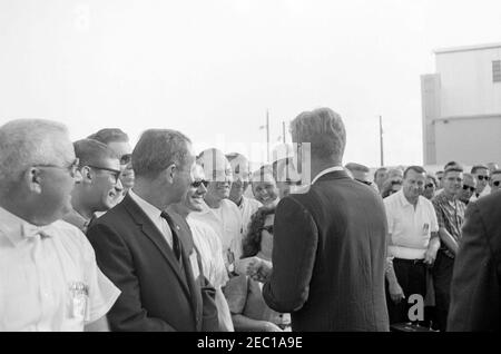 Inspection tour of NASA installations: Cape Canaveral Florida, 2:31PM. President John F. Kennedy (back to camera) greets site workers at Cape Canaveral Air Force Station, Cape Canaveral, Florida, following a tour of the facilities at Hangar S. President Kennedy visited Cape Canaveral as part of a two-day inspection tour of National Aeronautics and Space Administration (NASA) field installations. Stock Photo