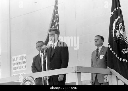 Inspection tour of NASA installations: Cape Canaveral Florida, 2:31PM. President John F. Kennedy (at microphones) delivers remarks, following a tour of Cape Canaveral Air Force Station, Cape Canaveral, Florida. Standing behind President Kennedy: Vice President Lyndon B. Johnson; Administrator of the National Aeronautics and Space Administration (NASA), Dr. James E. Webb. The President visited Cape Canaveral as part of a two-day inspection tour of NASA field installations. Stock Photo