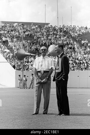 Inspection tour of NASA installations: Houston, Texas, motorcade, address at Rice University, 9:34AM. Special Assistants to President John F. Kennedy, Dave Powers and Kenneth P. Ou2019Donnell (right), stand on the field at Rice University Stadium, during President Kennedyu0027s visit to Rice University, Houston, Texas; spectators sit in the stands. Stock Photo