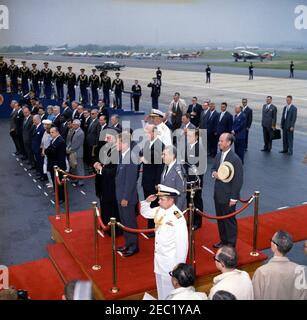 Arrival ceremony for Archbishop Makarios III, President of Cyprus, 11:00AM. President John F. Kennedy and President of the Republic of Cyprus, Archbishop Makarios III (both in center left), stand on the reviewing platform during arrival ceremonies in honor of Archbishop Makarios III. Also standing on platform (L-R): Minister of Foreign Affairs of the Republic of Cyprus, Spyros Kyprianou (partially hidden); U.S. Secretary of State, Dean Rusk; Chief of Naval Operations, Admiral George W. Anderson, Jr. (U.S.N.); Ambassador of the Republic of Cyprus, Zenon Rossides (in front, left of microphones); Stock Photo