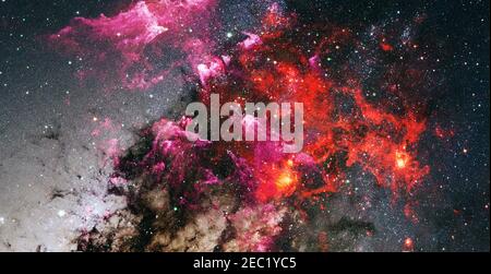 Giant glowing nebula. Space background with red nebula and stars. Elements of this image furnished by NASA. Stock Photo