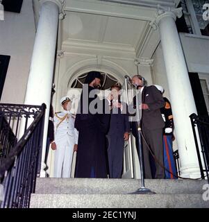 Arrival ceremony for Archbishop Makarios III, President of Cyprus, 11:00AM. Chairman of the Board of Commissioners of the District of Columbia, Walter N. Tobriner, presents a key to the City of Washington to President of the Republic of Cyprus, Archbishop Makarios III. Left to right (flanked by two United States Marines): Naval Aide to President Kennedy, Captain Tazewell T. Shepard, Jr.; Archbishop Makarios III; President John F. Kennedy; Chairman Tobriner (face obscured by microphones). Blair House, Washington, D.C. Stock Photo