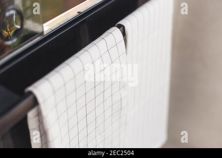 Heavy traditional cast iron cooker for cooking food. A kitchen towel hangs on a handle. Stock Photo