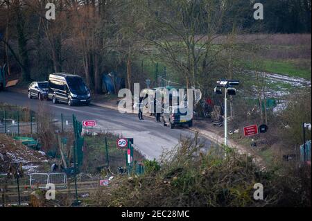 Harefield, Uxbridge, Middlesex, UK. 13th February, 2021. Bailiffs at the camp this morning. The National Eviction Team Enforcement Agent Bailiffs evicted Stop HS2 activists from their camp in Harvil Road in the early hours this morning. Two protesters remain in trees at the site. HS2 have closed Harvil Road off from today until 21st February. Numerous HS2 Security personnel were blocking access to the road this morning. HS2 Ltd are building a viaduct across Harvil Road for the controversial High Speed Rail 2 link from London to Birmingham and have destroyed acres of trees and countryside in th Stock Photo