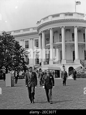 First Lady Jacqueline Kennedyu0027s (JBK) Musical Program for Youth, 2:10PM. President John F. Kennedy walks with an unidentified military official across the South Lawn of the White House to attend the sixth installment of First Lady Jacqueline Kennedyu2019s Musical Programs for Youth by Youth. Washington, D.C. Stock Photo