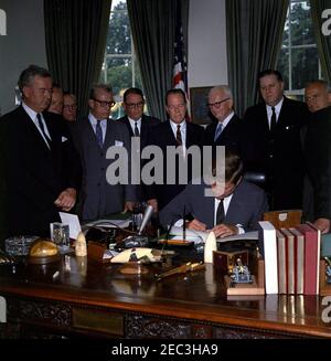 Bill signing - S. 2996 Public Law 87-565, Foreign Assistance Act, 10:29AM. President John F. Kennedy signs the Foreign Assistance Act, S. 2996 Public Law 87-565. Looking on (L-R): Senator John J. Sparkman (Alabama); Representative Wayne L. Hays of Ohio (partially hidden); Representative Walter H. Judd (Minnesota); Senator Everett Dirksen (Illinois); Representative Robert B. Chiperfield (Illinois); Senator Thomas H. Kuchel (California); Representative Francis E. Walter (Pennsylvania); Representative Thomas E. Morgan (Pennsylvania); Representative Peter Frelinghuysen, Jr. (New Jersey). Oval Offi Stock Photo