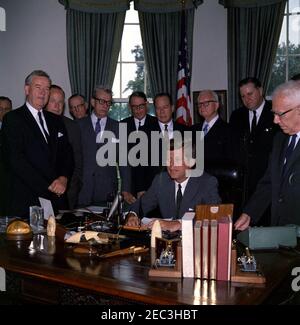 Bill signing - S. 2996 Public Law 87-565, Foreign Assistance Act, 10:29AM. President John F. Kennedy delivers remarks upon signing the Foreign Assistance Act, S. 2996 Public Law 87-565. Looking on (L-R): Senator Mike Mansfield of Montana (in background); Senator John J. Sparkman (Alabama); Representative Wayne L. Hays (Ohio); Representative Walter H. Judd (Minnesota); Senator Everett Dirksen (Illinois); Representative Robert B. Chiperfield (Illinois); Senator Thomas H. Kuchel (California); Representative Francis E. Walter (Pennsylvania); Representative Thomas E. Morgan (Pennsylvania); Senator Stock Photo