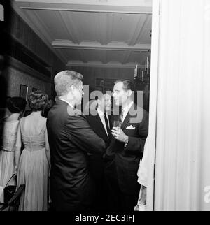 Trip to New York City: Reception, Arthur Krim Residence. President John F. Kennedy visits with an unidentified man during an evening reception at the residence of Arthur B. Krim and Dr. Mathilde Krim in New York City, New York. Stock Photo