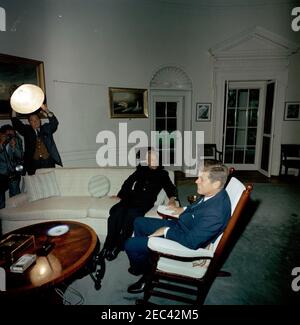 Meeting with Dr. Sarvepalli Radhakrishnan, President of India, 4:35PM. President John F. Kennedy (in rocking chair) meets with President of India, Dr. Sarvepalli Radhakrishnan. Persons at left are unidentified. Oval Office, White House, Washington, D.C. Stock Photo