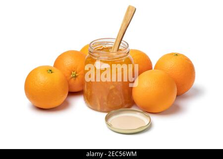Homemade orange marmelade in glass jar and fresh oranges in the background Stock Photo