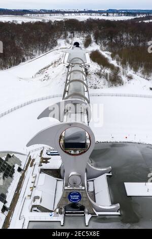 Falkirk, Scotland, UK. 13th Feb, 2021. Pictured: The Falkirk Wheel, surrounded by snow and ice. Scotland was subjected to one of the coldest nights again. The Met Office has issued a yellow weather warning for snow and ice for the next 24 hours. The Falkirk Wheel is a rotating boat lift in central Scotland, connecting the Forth and Clyde Canal with the Union Canal. The lift is named after Falkirk, the town in which it is located. It reconnects the two canals for the first time since the 1930s. It opened in 2002 as part of the Millennium Link project. Credit: Colin Fisher/Alamy Live News Stock Photo