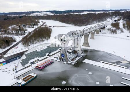 Falkirk, Scotland, UK. 13th Feb, 2021. Pictured: The Falkirk Wheel, surrounded by snow and ice. Scotland was subjected to one of the coldest nights again. The Met Office has issued a yellow weather warning for snow and ice for the next 24 hours. The Falkirk Wheel is a rotating boat lift in central Scotland, connecting the Forth and Clyde Canal with the Union Canal. The lift is named after Falkirk, the town in which it is located. It reconnects the two canals for the first time since the 1930s. It opened in 2002 as part of the Millennium Link project. Credit: Colin Fisher/Alamy Live News Stock Photo