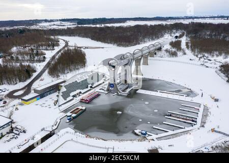 Falkirk, Scotland, UK. 13th Feb, 2021. Pictured: The Falkirk Wheel, surrounded by snow and ice. Scotland was subjected to one of the coldest nights again. The Met Office has issued a yellow weather warning for snow and ice for the next 24 hours. The Falkirk Wheel is a rotating boat lift in central Scotland, connecting the Forth and Clyde Canal with the Union Canal. The lift is named after Falkirk, the town in which it is located. It reconnects the two canals for the first time since the 1930s. It opened in 2002 as part of the Millennium Link project. Credit: Colin Fisher/Alamy Live News Stock Photo