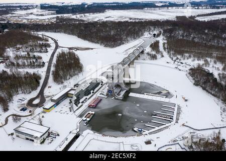 Falkirk, Scotland, UK. 13th Feb, 2021. Pictured: The Falkirk Wheel, surrounded by snow and ice. Scotland was subjected to one of the coldest nights again. The Met Office has issued a yellow weather warning for snow and ice for the next 24 hours. The Falkirk Wheel is a rotating boat lift in central Scotland, connecting the Forth and Clyde Canal with the Union Canal. The lift is named after Falkirk, the town in which it is located. It reconnects the two canals for the first time since the 1930s. It opened in 2002 as part of the Millennium Link project. Credit: Colin Fisher/Alamy Live News Stock Photo