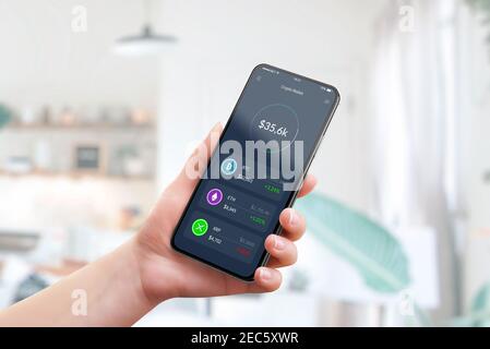 Cryptocurrency market value on smart phone app concept. Woman holding smart phone with Crypto wallet Stock Photo
