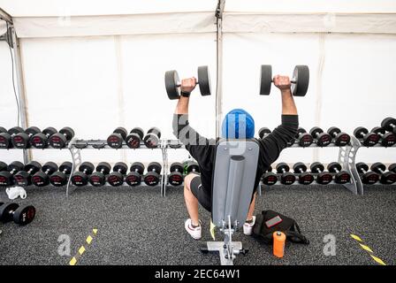 Berlin, Germany. 13th Feb, 2021. A man works out in a tent outside a gym. A gym chain opens several outdoor gyms with a special hygiene concept even during the lockdown. Credit: Fabian Sommer/dpa/Alamy Live News Stock Photo